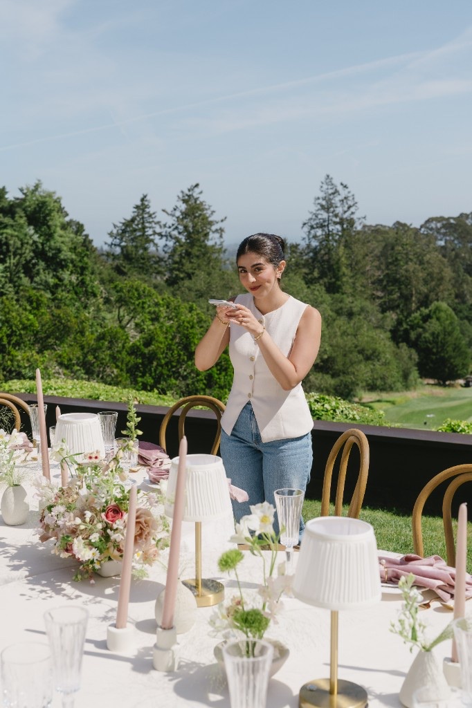 Kate capturing content at a styled outdoor table setting